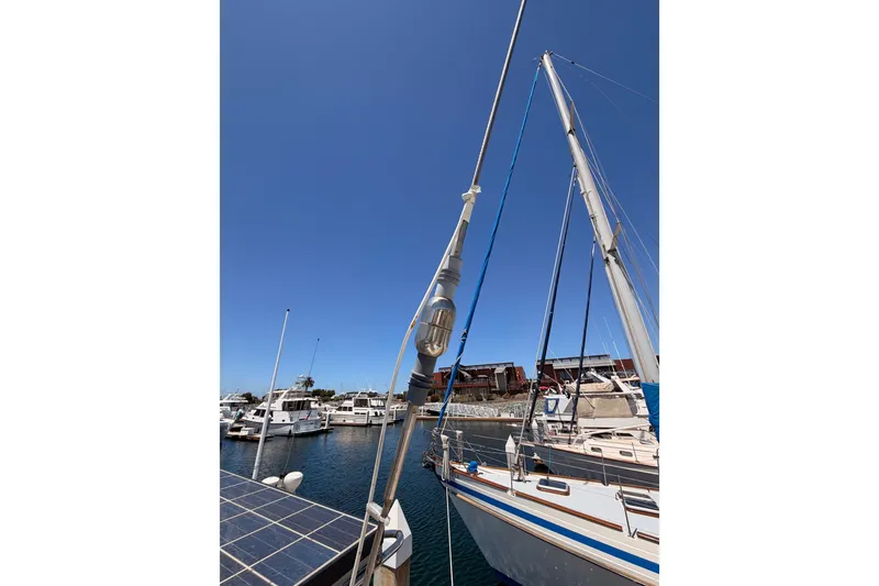 Slide: The Image of Sailboat Tayana 48, 2005 model, docked in a marina under clear blue skies. - 30