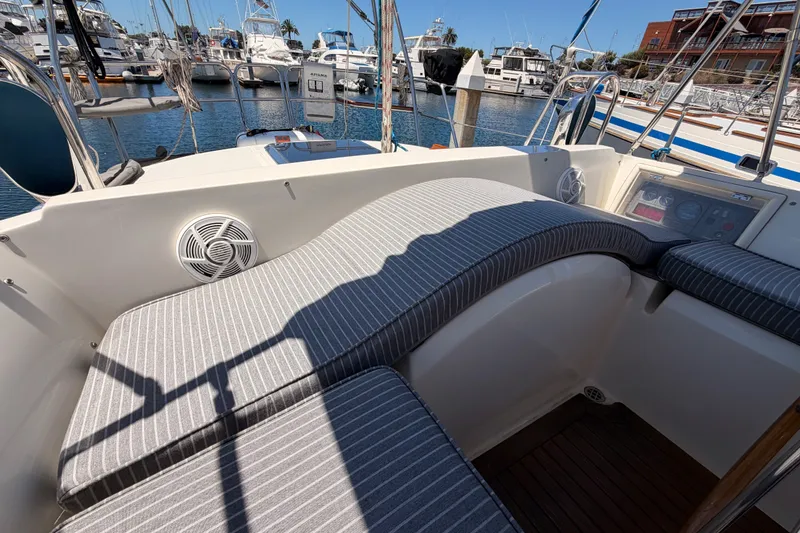 Slide: The Image of Cockpit of 2005 Tayana 48 yacht with striped cushions, docked in a marina. - 39