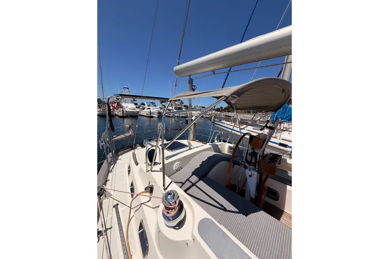 Slide: The Image of Sailboat Tayana 48, 2005 model, docked at marina under clear blue sky. - 24