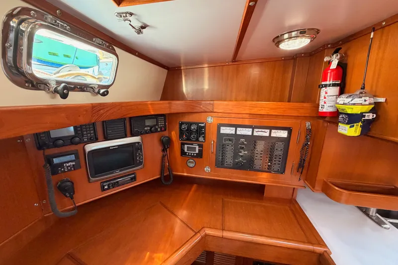 Slide: The Image of Navigation station of 2005 Tayana 48 yacht with control panels and equipment. - 50