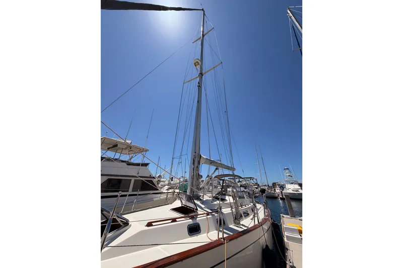 Slide: The Image of Sailboat Tayana 48, 2005 model, docked under clear blue sky. - 4