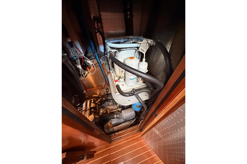 Slide: The Image of Engine room of 2005 Tayana 48 yacht with visible mechanical components. - 105