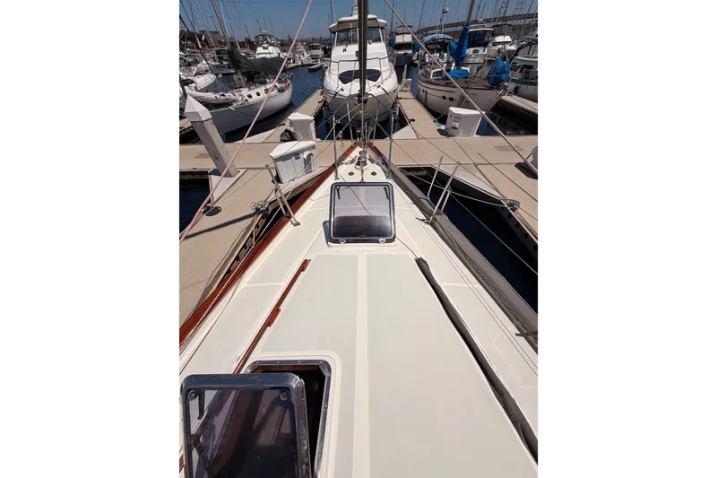 Slide: The Image of 2005 Tayana 48 sailboat docked at marina, showcasing deck and rigging. - 15