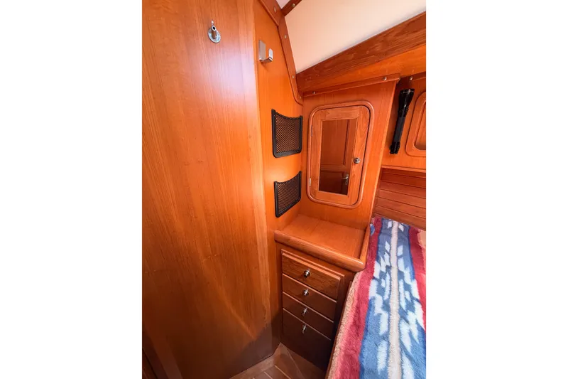 Slide: The Image of Interior of 2005 Tayana 48 yacht with wooden cabinetry and cozy bedding. - 68