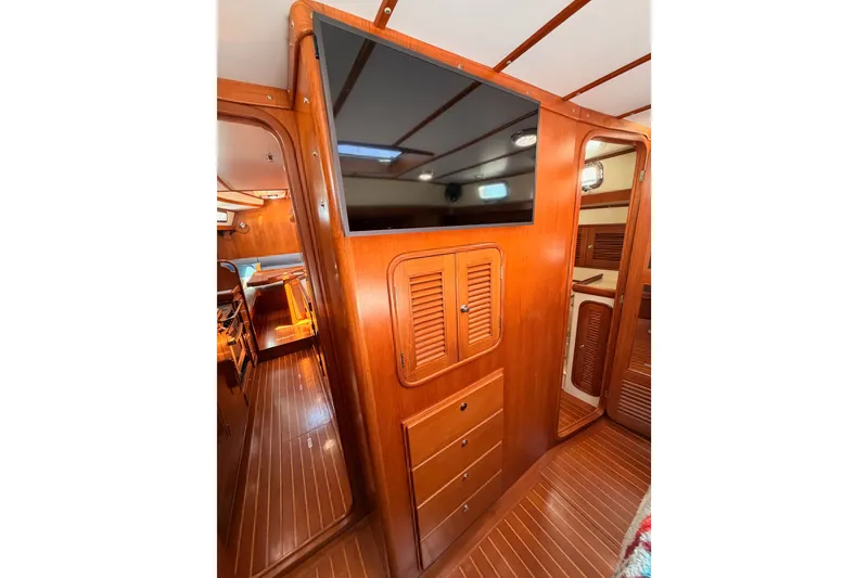Slide: The Image of Interior of 2005 Tayana 48 yacht with wooden cabinetry and mounted TV. - 87