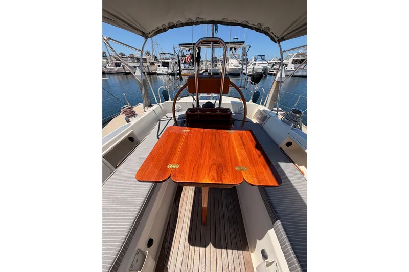Slide: The Image of Cockpit of 2005 Tayana 48 sailboat with wooden table, docked at marina. - 37