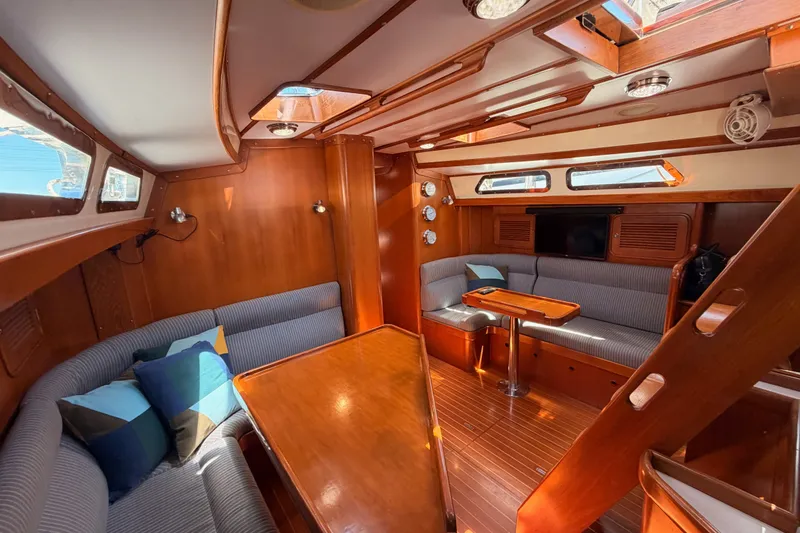 Slide: The Image of Interior of 2005 Tayana 48 yacht with wood finish and cozy seating area. - 99