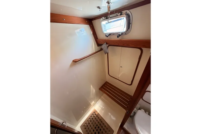 Slide: The Image of Interior of 2005 Tayana 48 yacht bathroom with wooden accents and porthole window. - 92