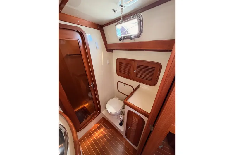 Slide: The Image of Luxurious 2005 Tayana 48 yacht bathroom with wooden accents and modern fixtures. - 89