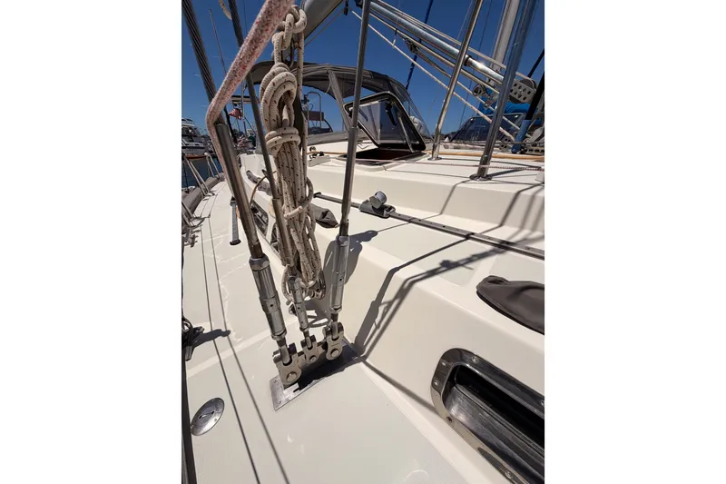 Slide: The Image of Deck view of 2005 Tayana 48 sailboat, showcasing rigging and hardware under clear blue sky. - 22