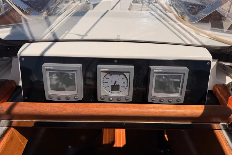 Slide: The Image of Cockpit instruments on a 2005 Tayana 48 yacht, featuring Raymarine displays. - 43
