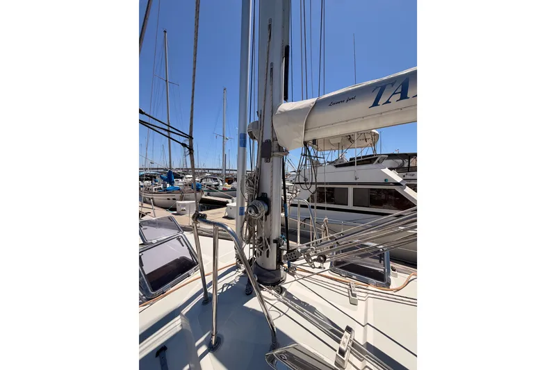 Slide: The Image of Sailboat deck view of 2005 Tayana 48, docked in a marina under clear blue sky. - 13