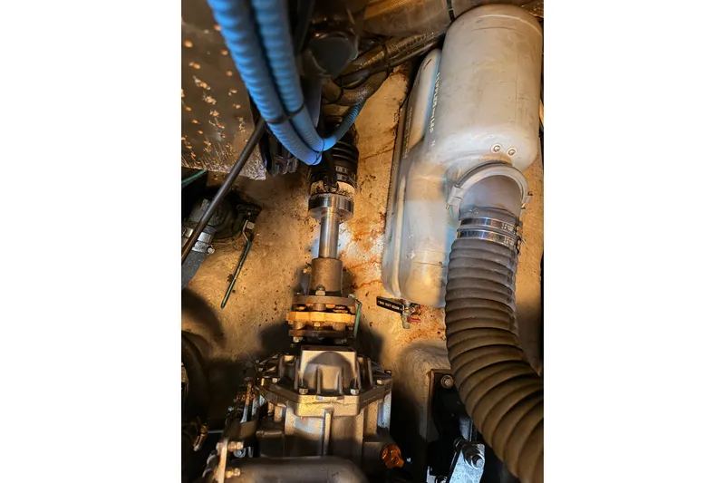 Slide: The Image of Engine compartment of a 2005 Tayana 48 yacht, featuring hoses and mechanical components. - 107