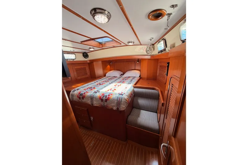 Slide: The Image of Cozy cabin interior of 2005 Tayana 48 yacht with wooden finish and bed. - 83