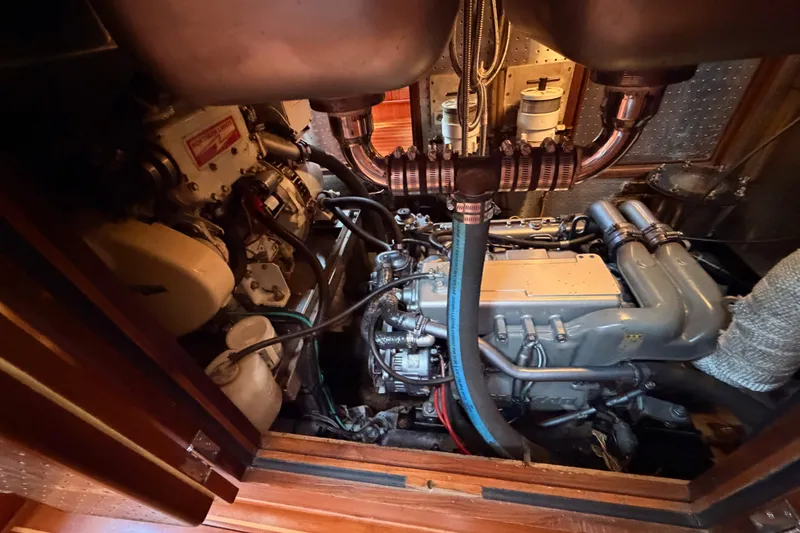 Slide: The Image of Engine room of a 2005 Tayana 48 yacht, showcasing detailed mechanical components. - 101