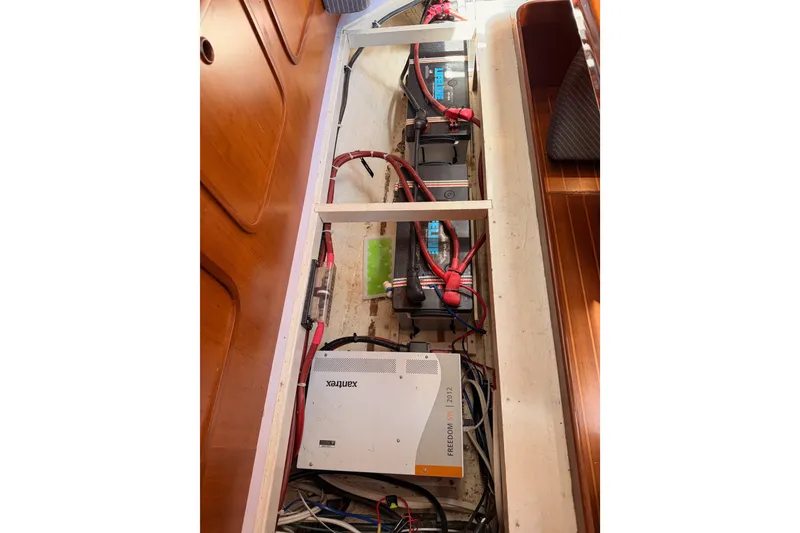 Slide: The Image of Electrical system of a 2005 Tayana 48 yacht, featuring batteries and wiring. - 120
