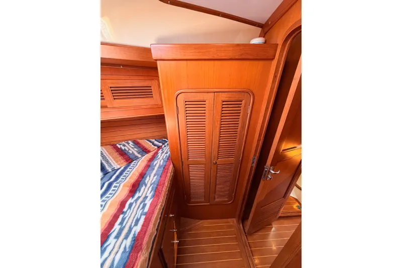 Slide: The Image of Wooden interior of 2005 Tayana 48 yacht cabin with colorful bedding and closet. - 70