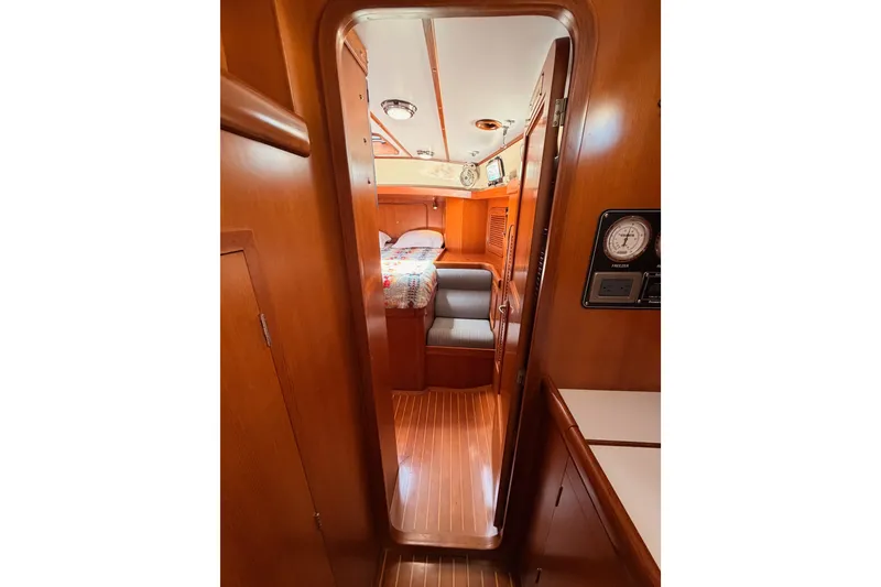 Slide: The Image of Interior view of 2005 Tayana 48 yacht cabin with wood finish and cozy seating. - 82
