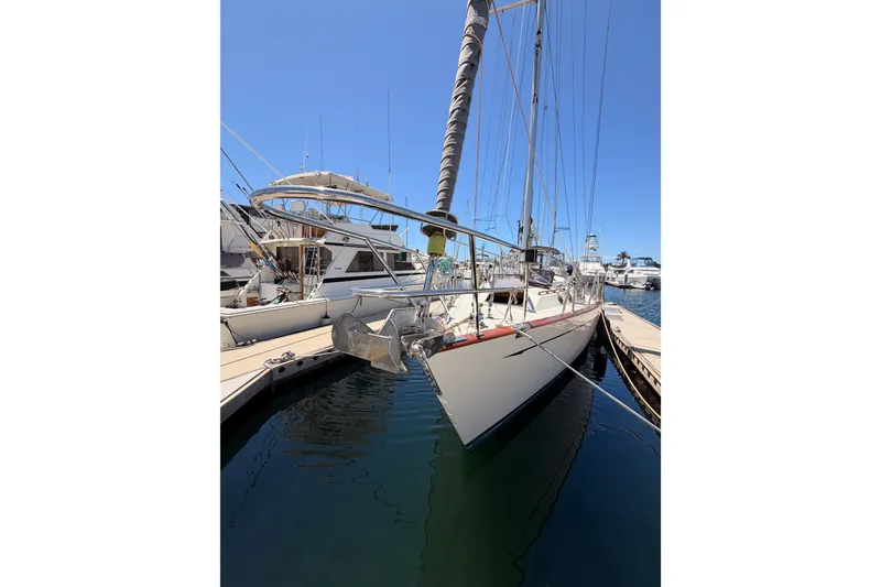 Slide: The Image of 2005 Tayana 48 sailboat docked at marina under clear blue sky. - 2