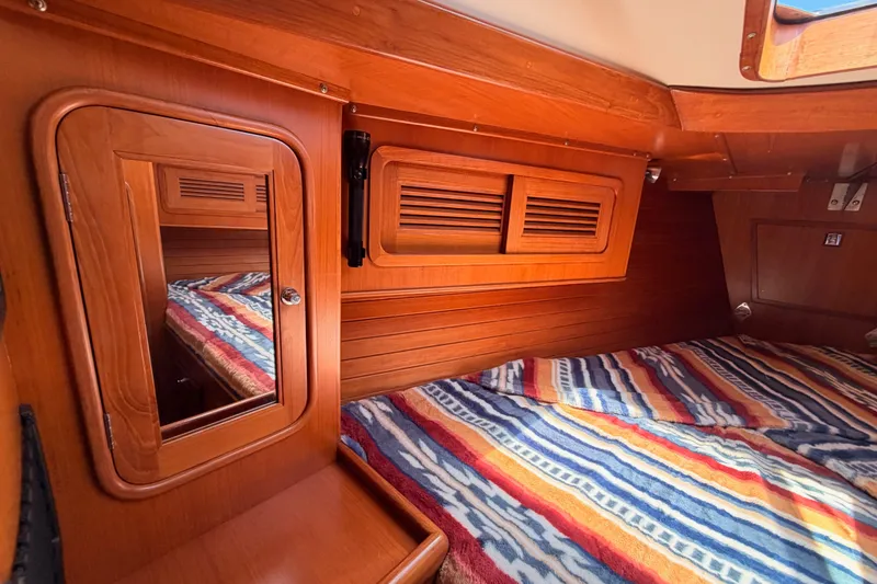 Slide: The Image of Cozy cabin interior of 2005 Tayana 48 yacht with wooden finish and colorful bedding. - 69