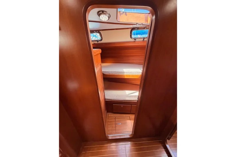 Slide: The Image of Interior view of 2005 Tayana 48 sailboat cabin with wooden finish and cozy seating. - 63