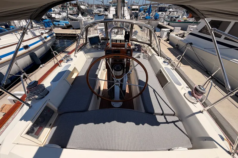 Slide: The Image of Cockpit of 2005 Tayana 48 sailboat with wooden wheel, docked at marina. - 32