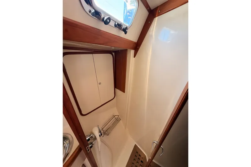 Slide: The Image of Interior of 2005 Tayana 48 yacht shower with wooden accents and storage cabinet. - 61