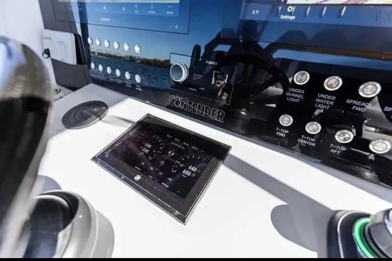 Slide: The Image of Control panel of 2022 Contender 44 CB boat with digital displays and controls. - 17