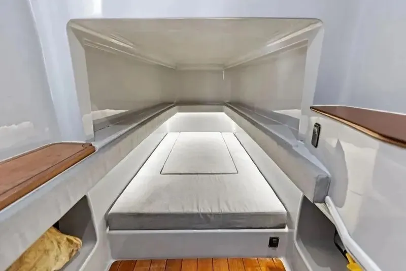 Slide: The Image of 2022 Contender 44 CB cabin interior with sleek design and comfortable bedding. - 20