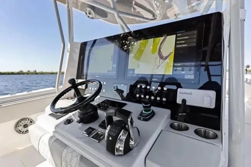 Slide: The Image of 2022 Contender 44 CB boat dashboard with advanced navigation system and controls. - 14