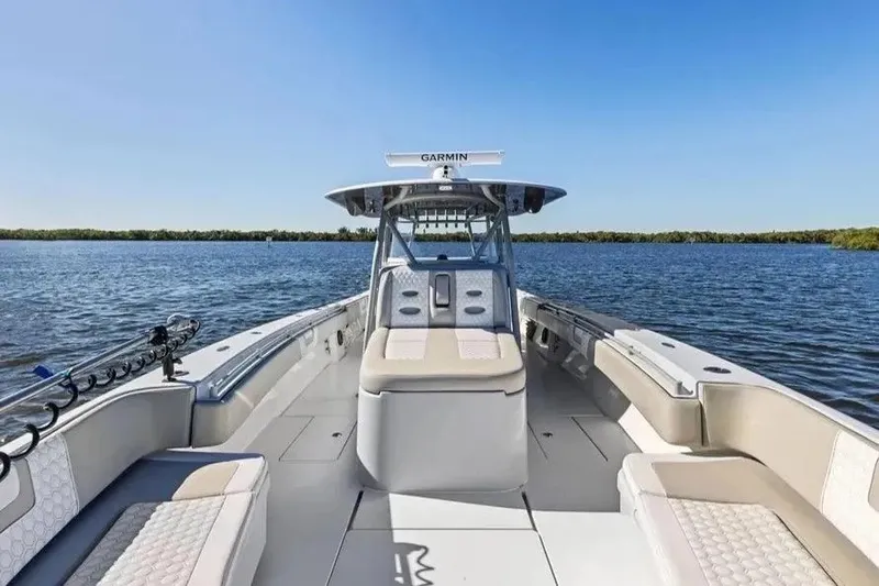 Slide: The Image of 2022 Contender 44 CB boat on calm water, featuring spacious seating and Garmin equipment. - 21