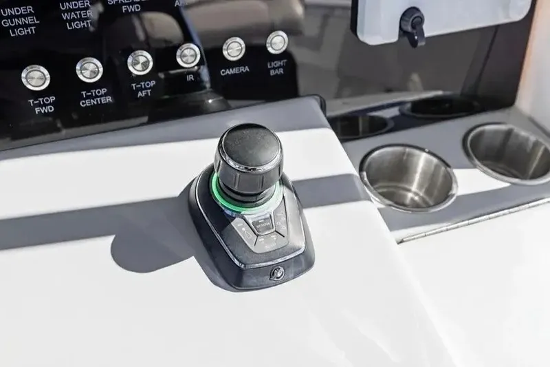 Slide: The Image of Control panel of 2022 Contender 44 CB boat with joystick and cup holders. - 16