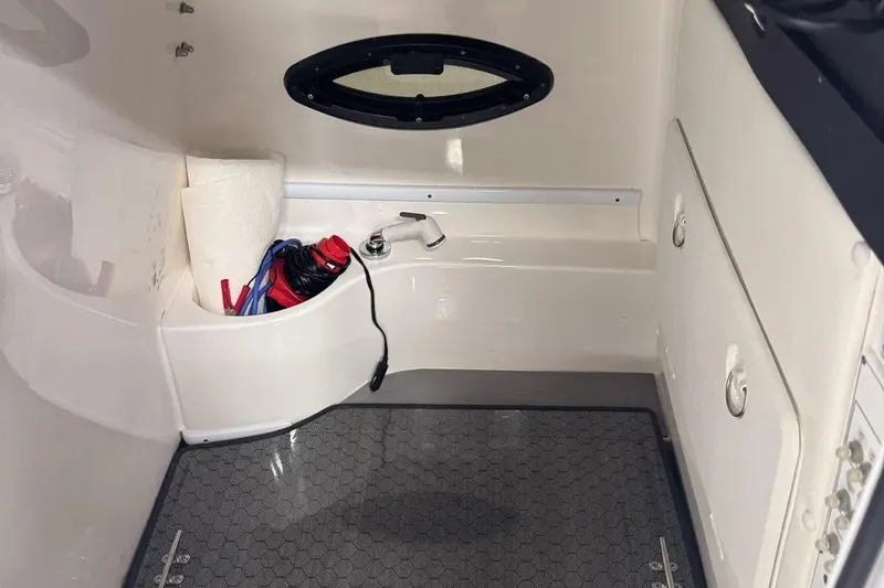 Slide: The Image of Interior of a 2022 Contender 32 ST boat, featuring storage and utility area. - 8