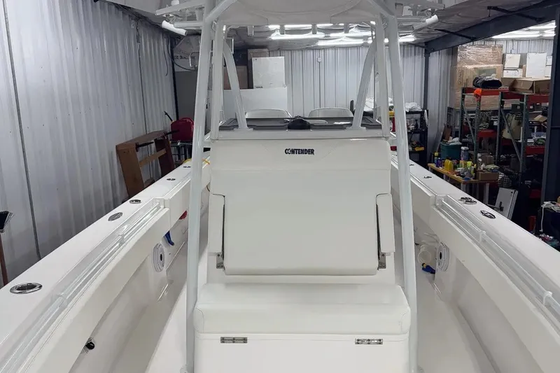 Slide: The Image of 2022 Contender 32 ST boat interior with white seating and storage in a garage. - 5