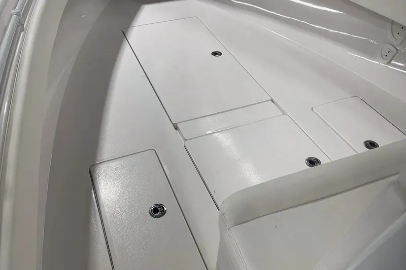 Slide: The Image of 2022 Contender 32 ST boat interior with sleek white deck and storage compartments. - 4