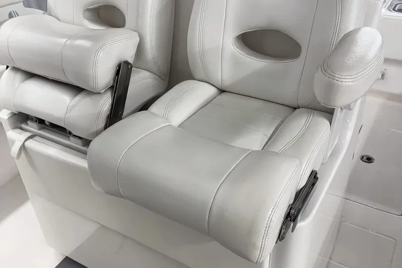 Slide: The Image of Luxurious seating in 2022 Contender 32 ST boat, featuring plush white upholstery and armrests. - 3
