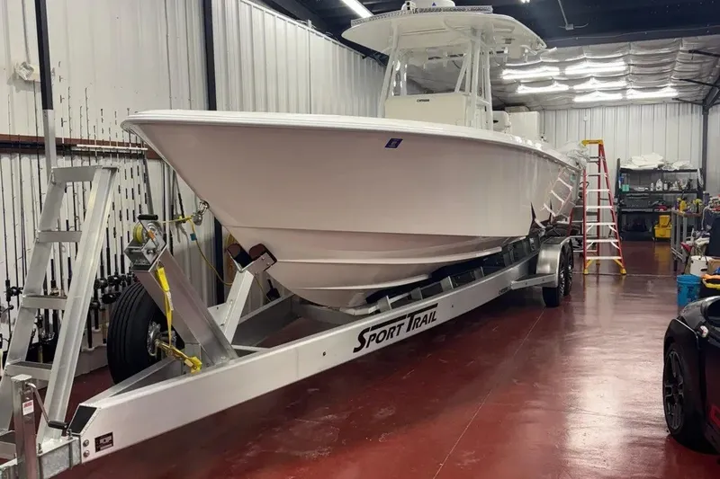 The Image of 2022 Contender 32 ST boat on trailer in a well-lit garage. - 1