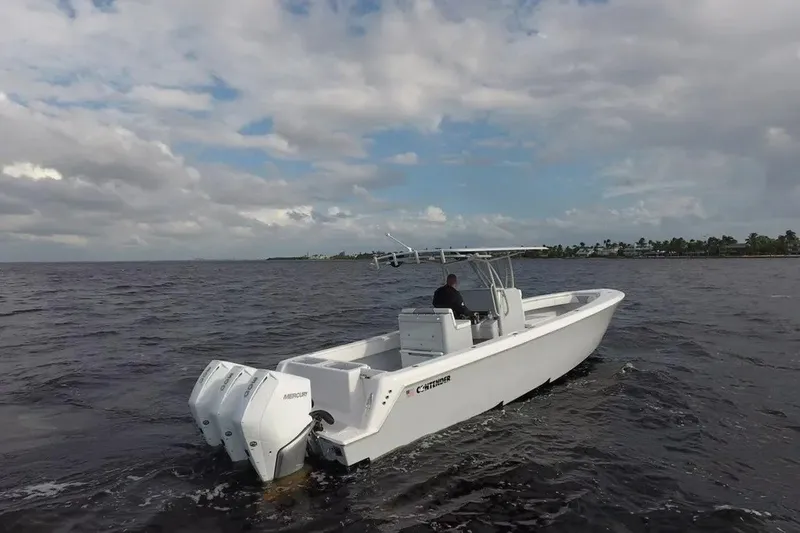 Slide: The Image of 2021 Contender 35 ST boat cruising on open water under cloudy skies. - 2
