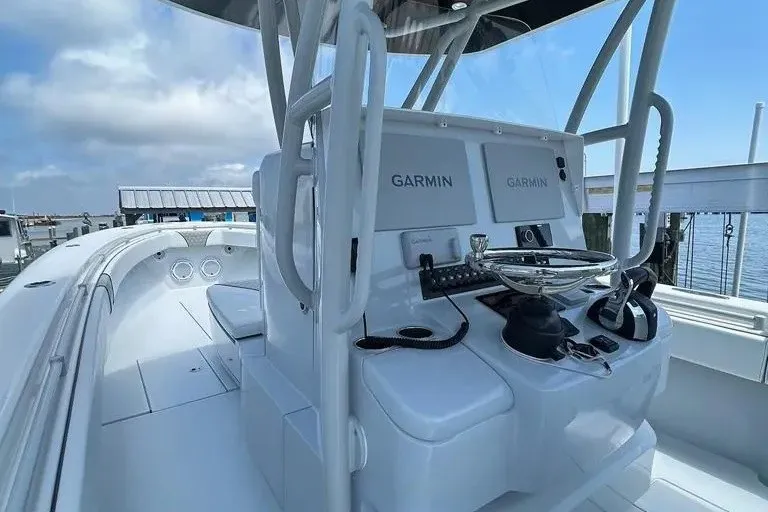Slide: The Image of 2021 Contender 35 ST boat cockpit with Garmin navigation systems, docked by the water. - 5