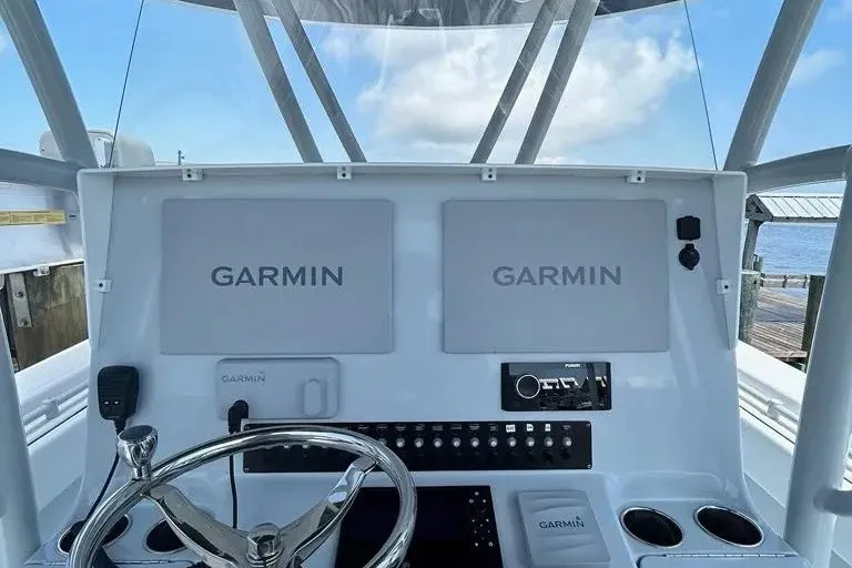 Slide: The Image of 2021 Contender 35 ST boat dashboard with dual Garmin displays and steering wheel. - 6