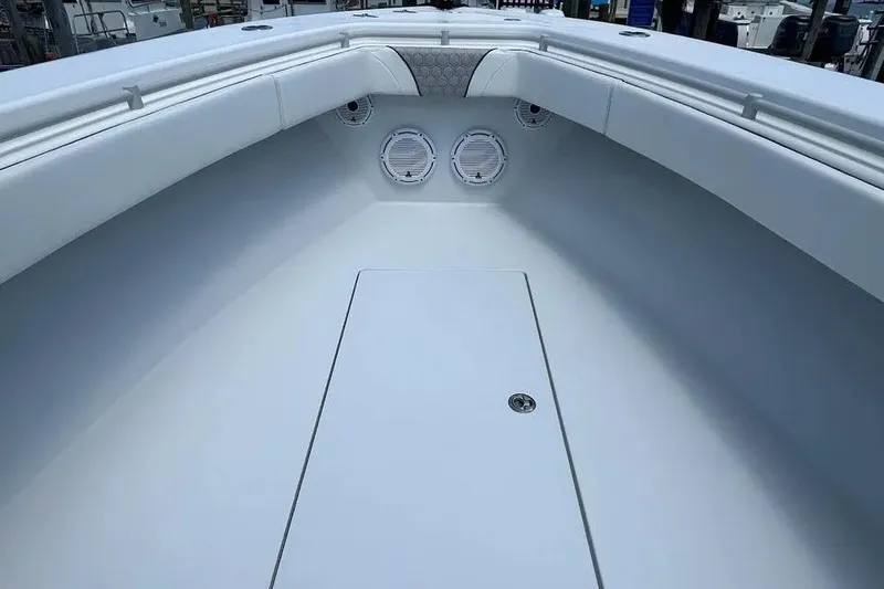 Slide: The Image of 2021 Contender 35 ST boat interior with sleek white seating and built-in speakers. - 8