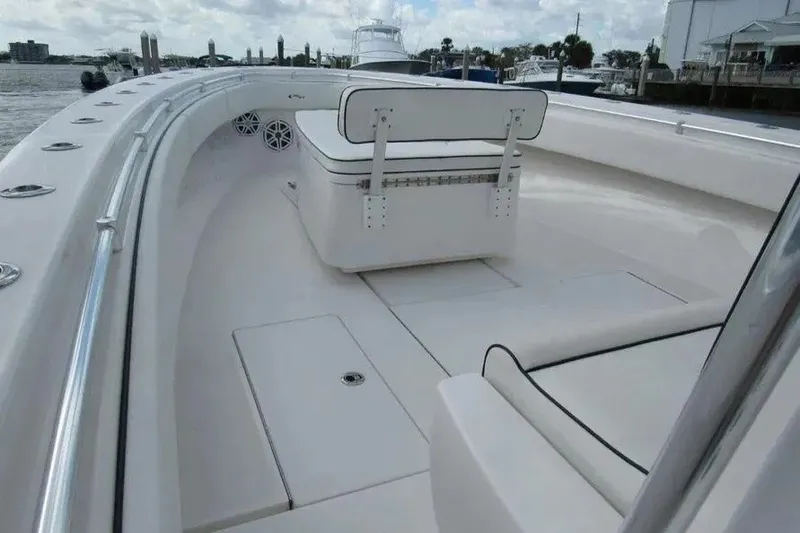Slide: The Image of 2019 Contender 39 ST boat deck with seating and storage, docked at marina. - 7