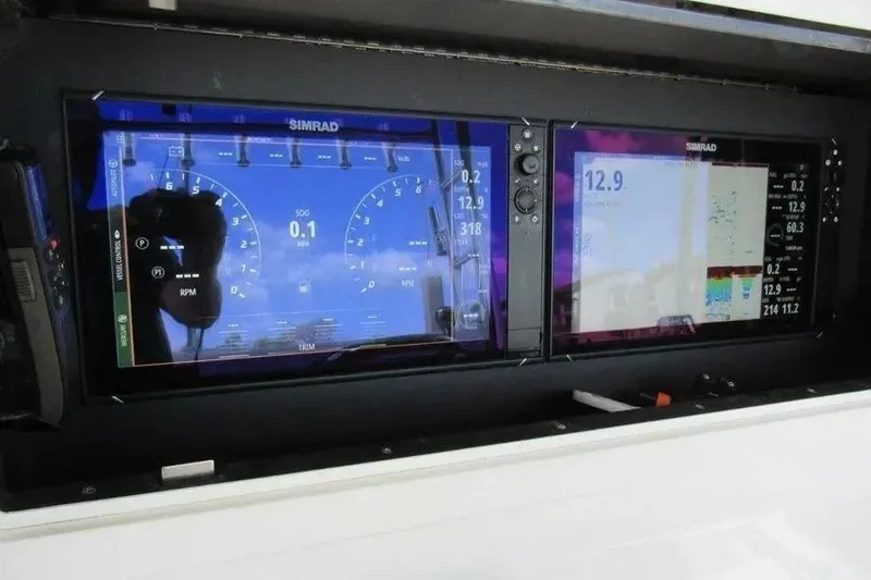 Slide: The Image of Simrad marine displays on 2019 Contender 39 ST dashboard, showing navigation and engine data. - 15