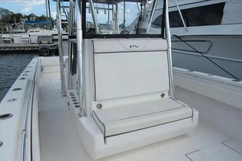 Slide: The Image of 2019 Contender 39 ST boat interior with seating and rod holders at a marina. - 8
