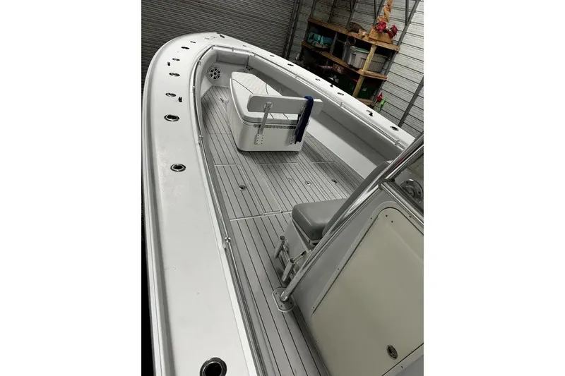Slide: The Image of 2014 Contender 39 ST boat interior with seating and storage in a garage setting. - 21