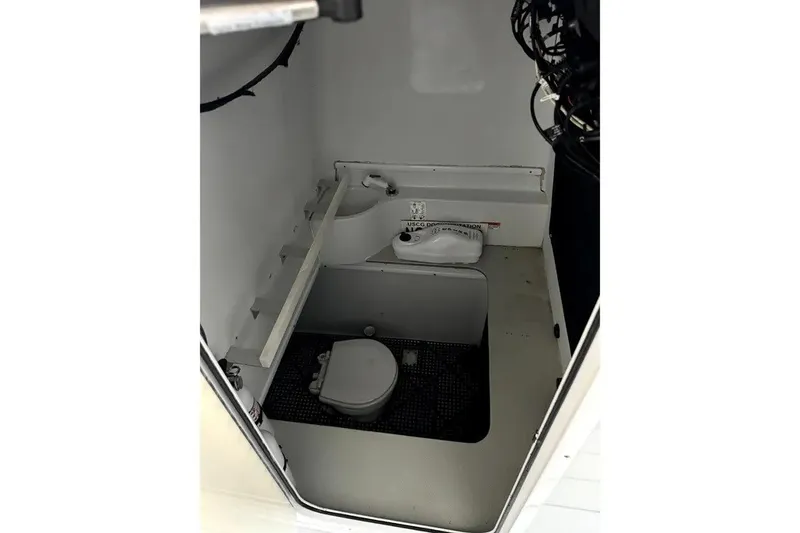 Slide: The Image of 2014 Contender 39 ST boat interior with compact marine toilet setup. - 18