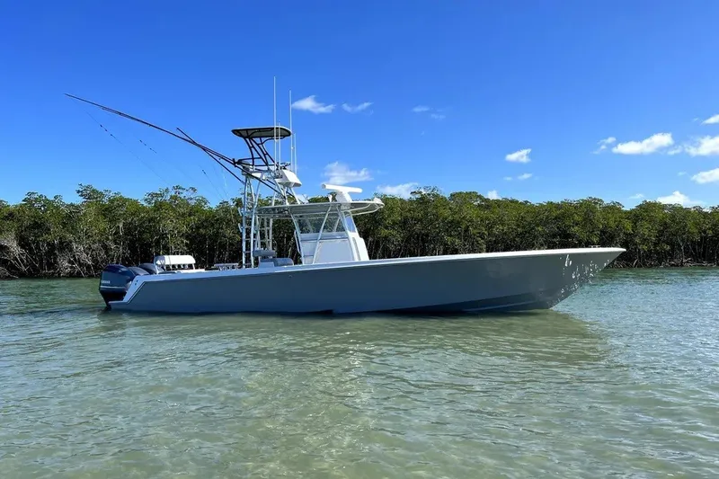The Image of 2014 Contender 39 ST boat on calm water with clear blue sky. - 1