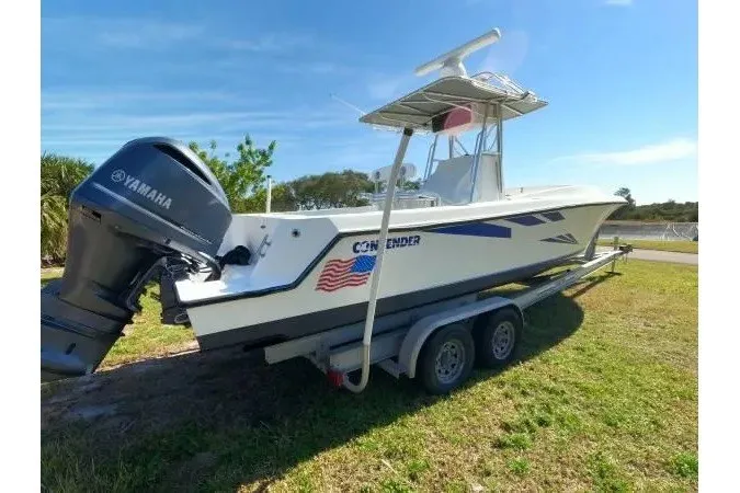 Slide: The Image of 1999 Contender 28 Sport boat on trailer with Yamaha outboard motor. - 16