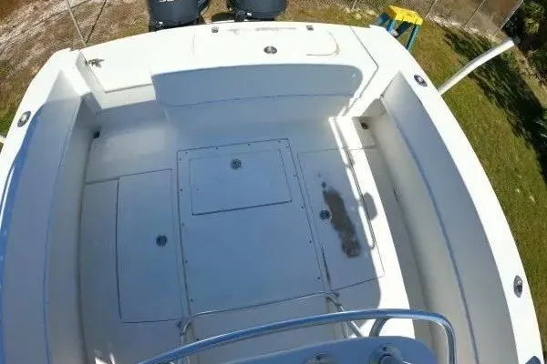 Slide: The Image of 1999 Contender 28 Sport boat deck, spacious layout, clean white surface, outdoor setting. - 12