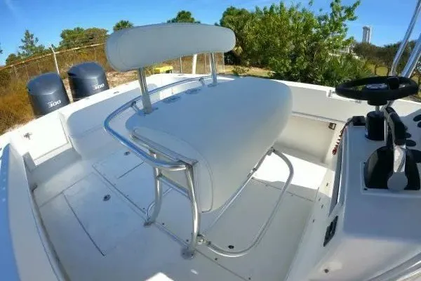 Slide: The Image of 1999 Contender 28 Sport boat interior with helm seat and dual engines. - 11